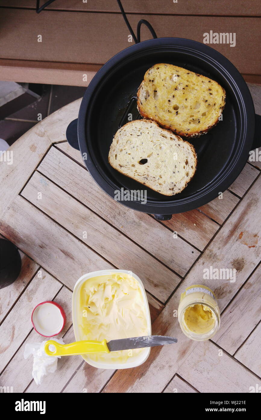 High Angle View Of Garlic Breads On Grill Over Table Stock Photo