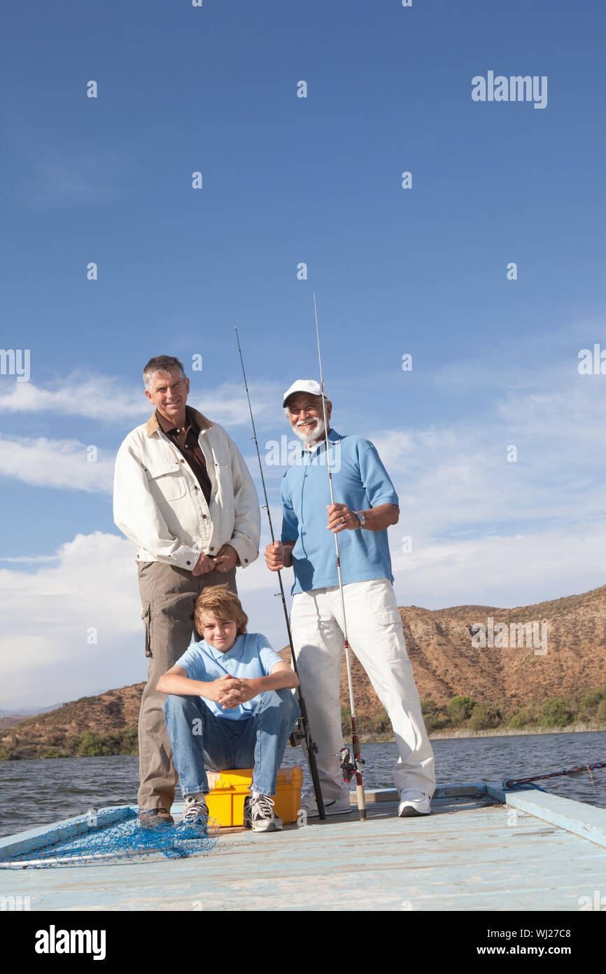Grandfather, father and son taking a selfie with fishing rods