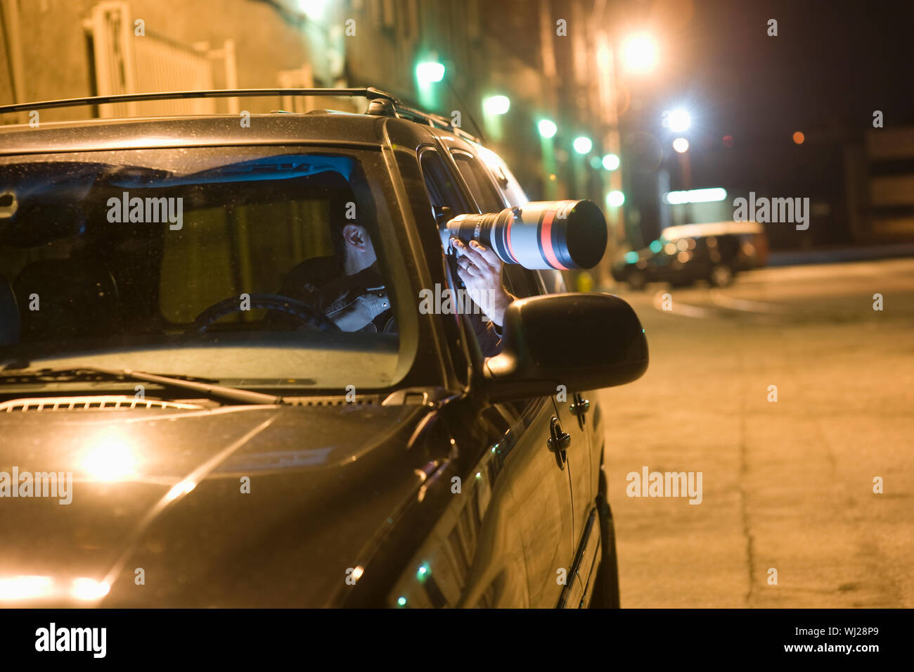 Professional photographer with telephoto lens in car Stock Photo Alamy