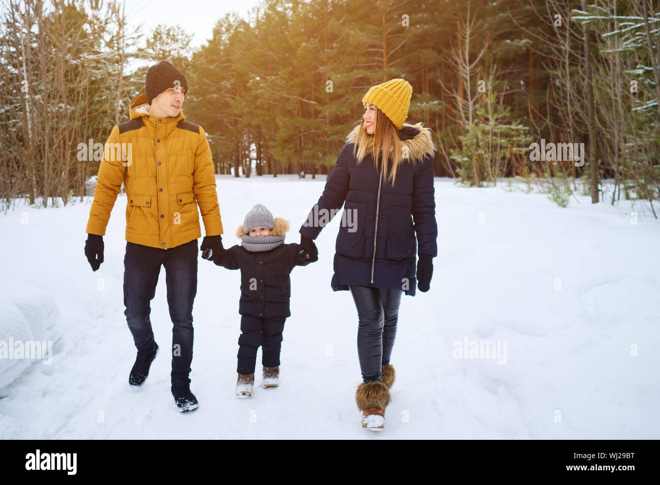 happy family walking in winter day in forest. Family, weekend and holiday concept Stock Photo