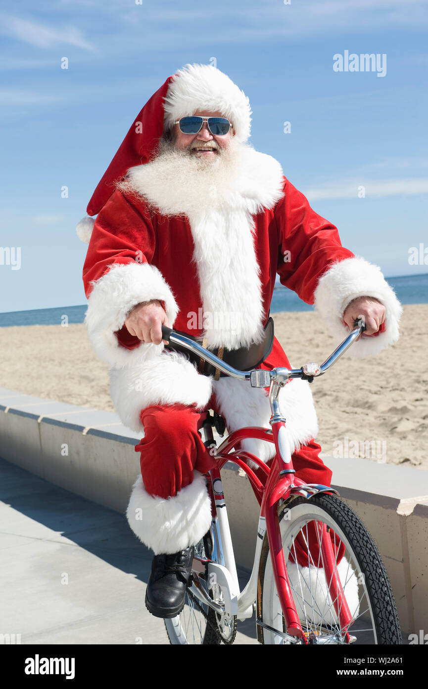 Santa Riding A Cycle Santa claus riding a bicycle hi-res stock photography and images - Alamy