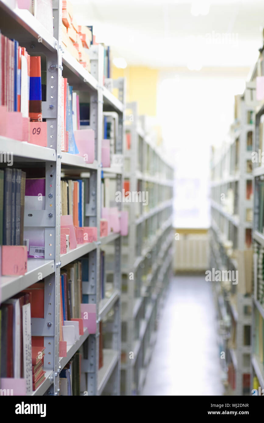 Color coded filing system on library shelves Stock Photo Alamy