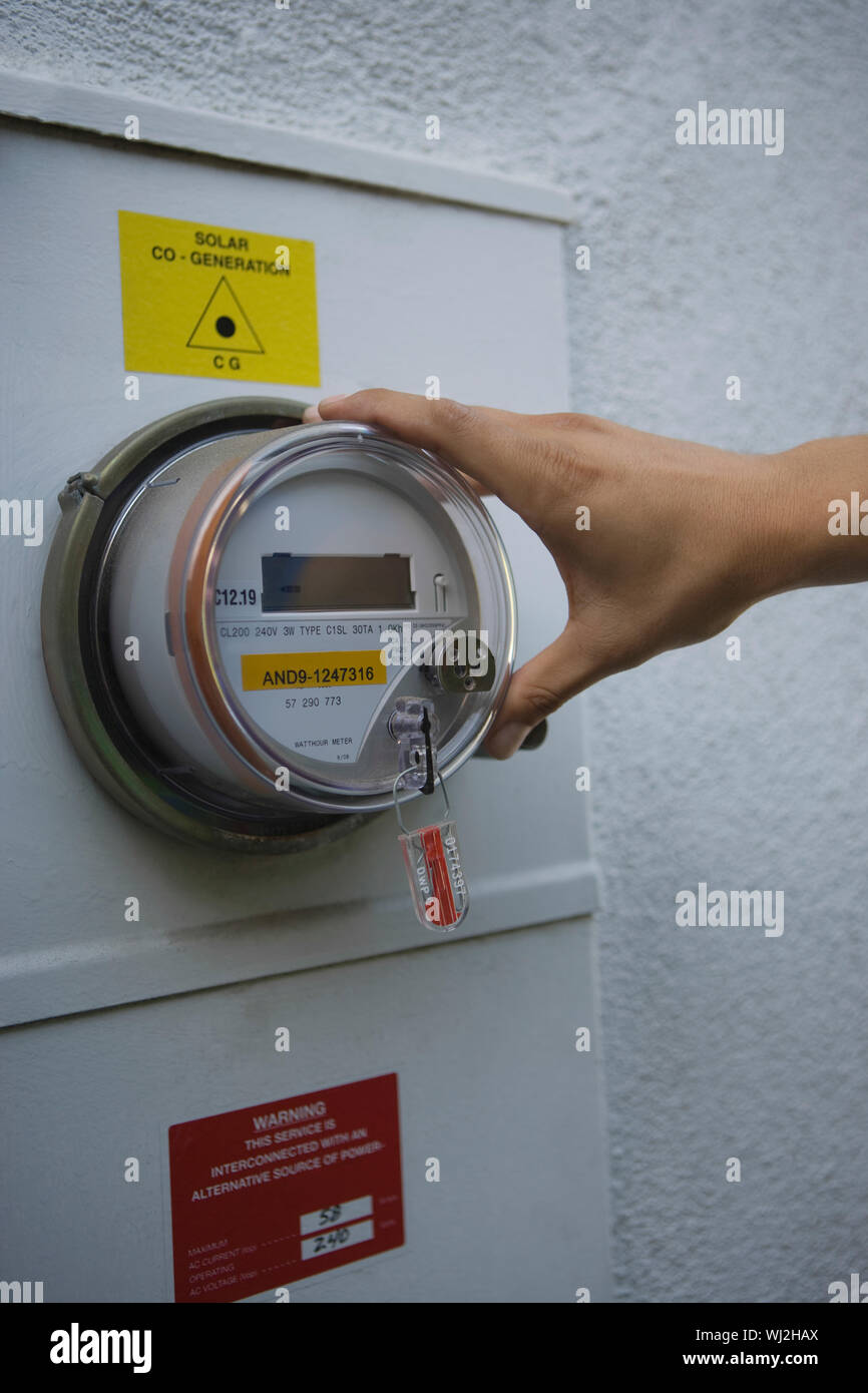 Hand on meter of solar generation unit in Los Angeles; California Stock ...
