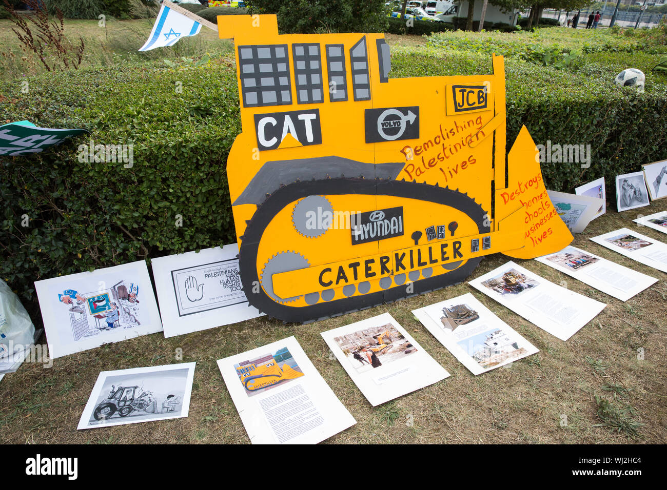 London, UK. 2 September, 2019. A model of a digger vehicle produced by companies such as Caterpillar, Volvo, JCB and Hyundai displayed by activists ou Stock Photo