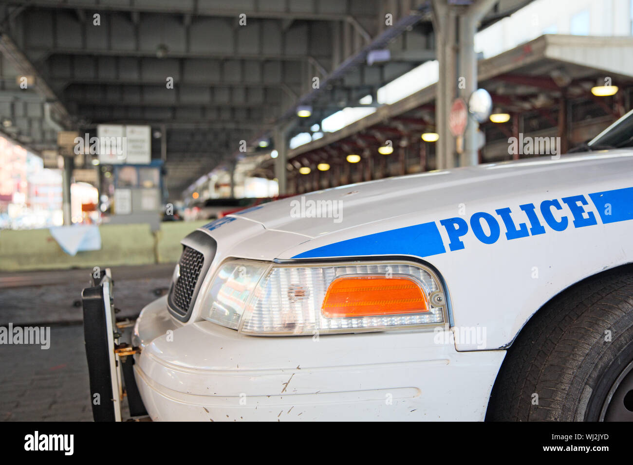 New York Police patrols the town. Forehead of a police car parked under a bridge. Nobody. Stock Photo