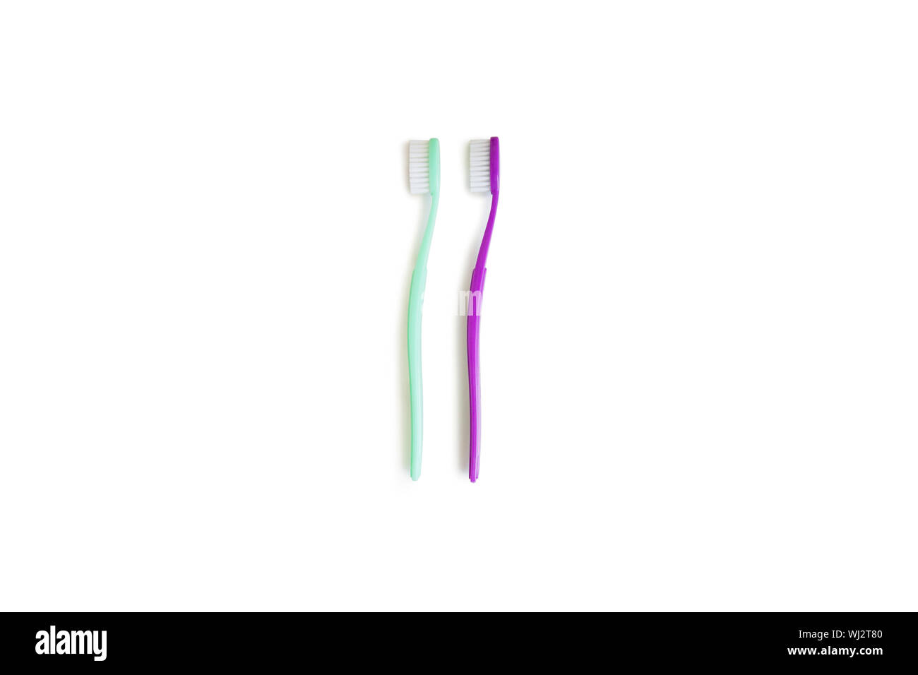 Two toothbrushes over white background Stock Photo - Alamy