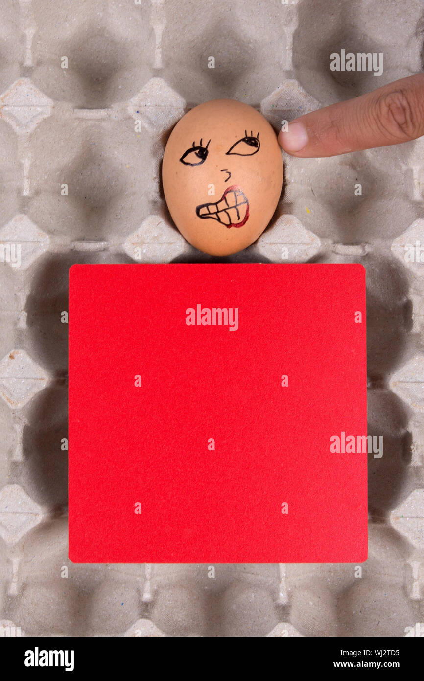 Closeup Of Human Finger Pointing Towards Egg With Anthropomorphic Face Stock Photo Alamy