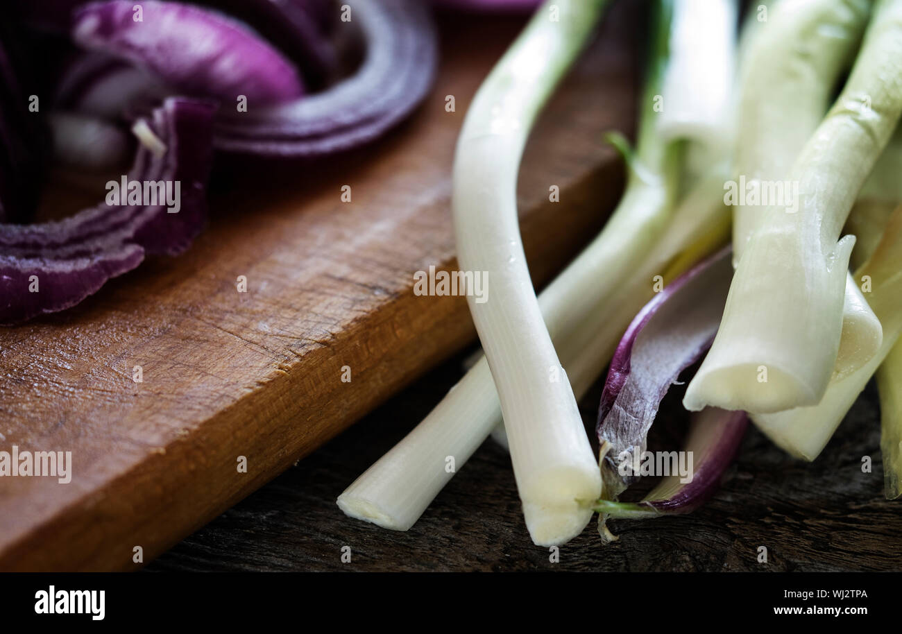 Close-up Of Scallions And Onions On Table Stock Photo