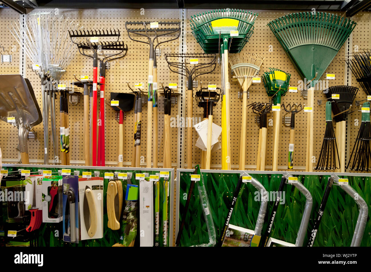 Gardening tools on display in store Stock Photo Alamy