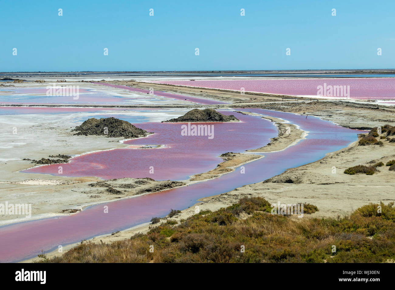 The Salin-de-Giraud salt farm with pink purple salty sea water in man-made  salin evaporation pans, salt mining in Camargue, Southern France, Europe  Stock Photo - Alamy