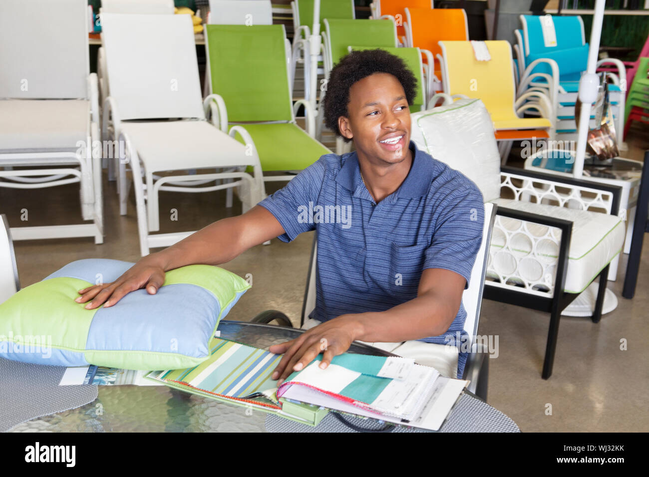 Male African American salesperson working in garden furniture store