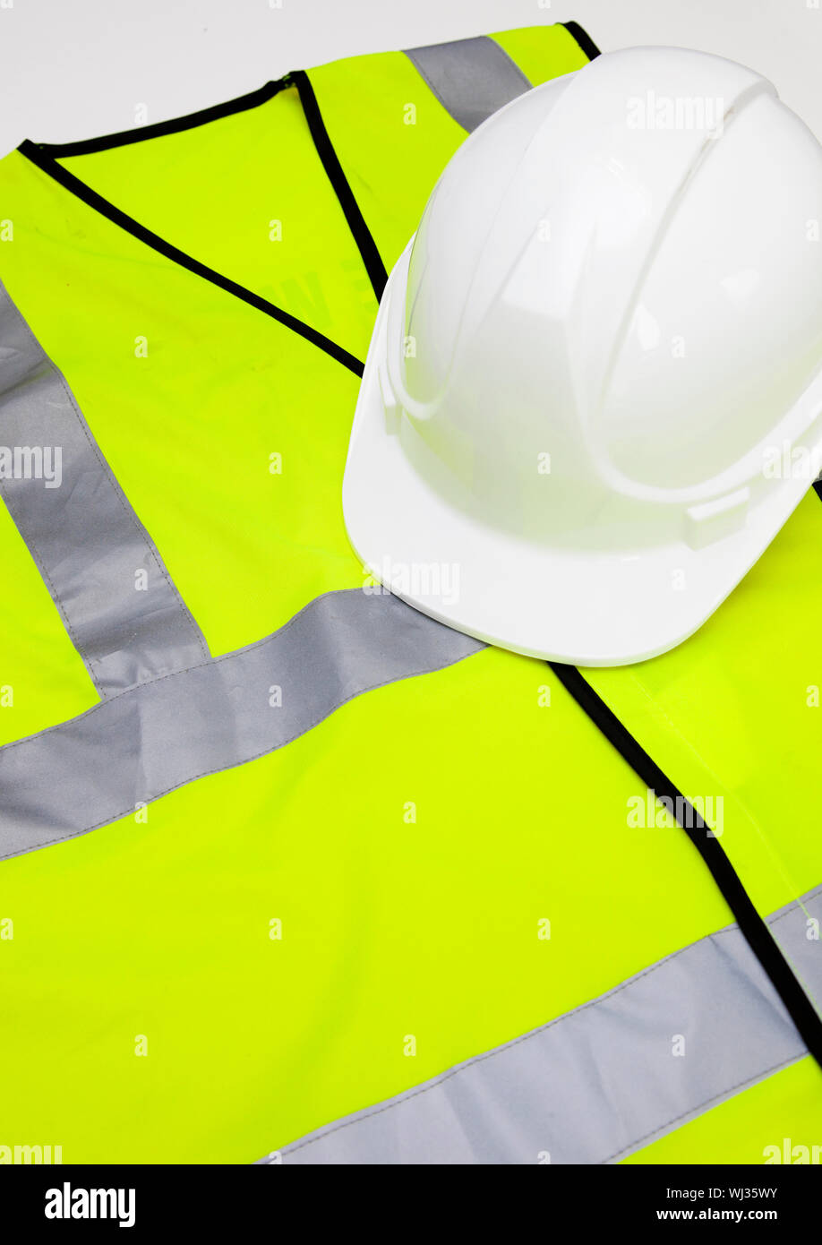 Safety vest and hard hat against white background Stock Photo Alamy