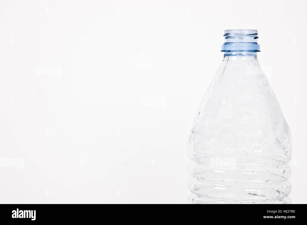 Close-up view of empty plastic bottle over white background Stock Photo ...