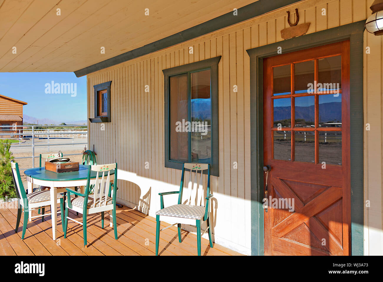 Ranch porch overlooking horse stables Stock Photo Alamy