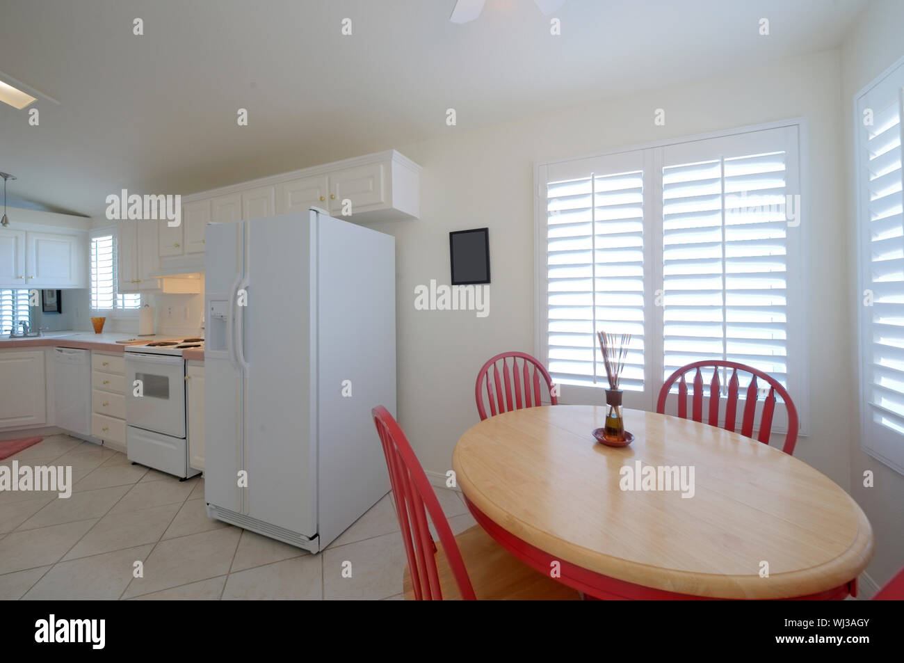 Classic kitchen with dining table with red chairs Stock Photo Alamy