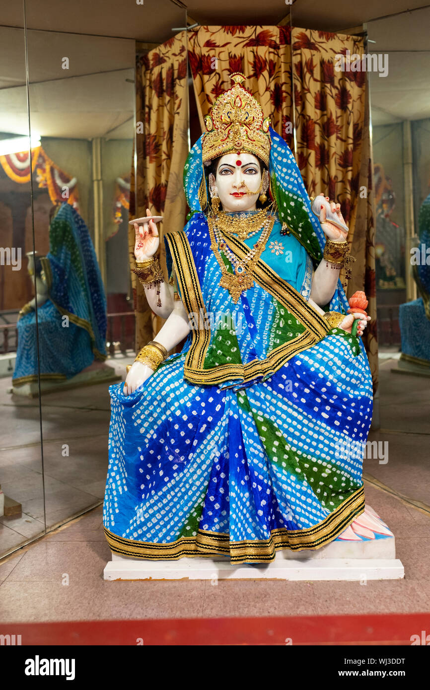 A statue of the Goddess Siddhidatri, a manifestation of the deity Durga,  dressed in blue & cyan at a Hindu temple in Woodside, Queens, New York City. Stock Photo