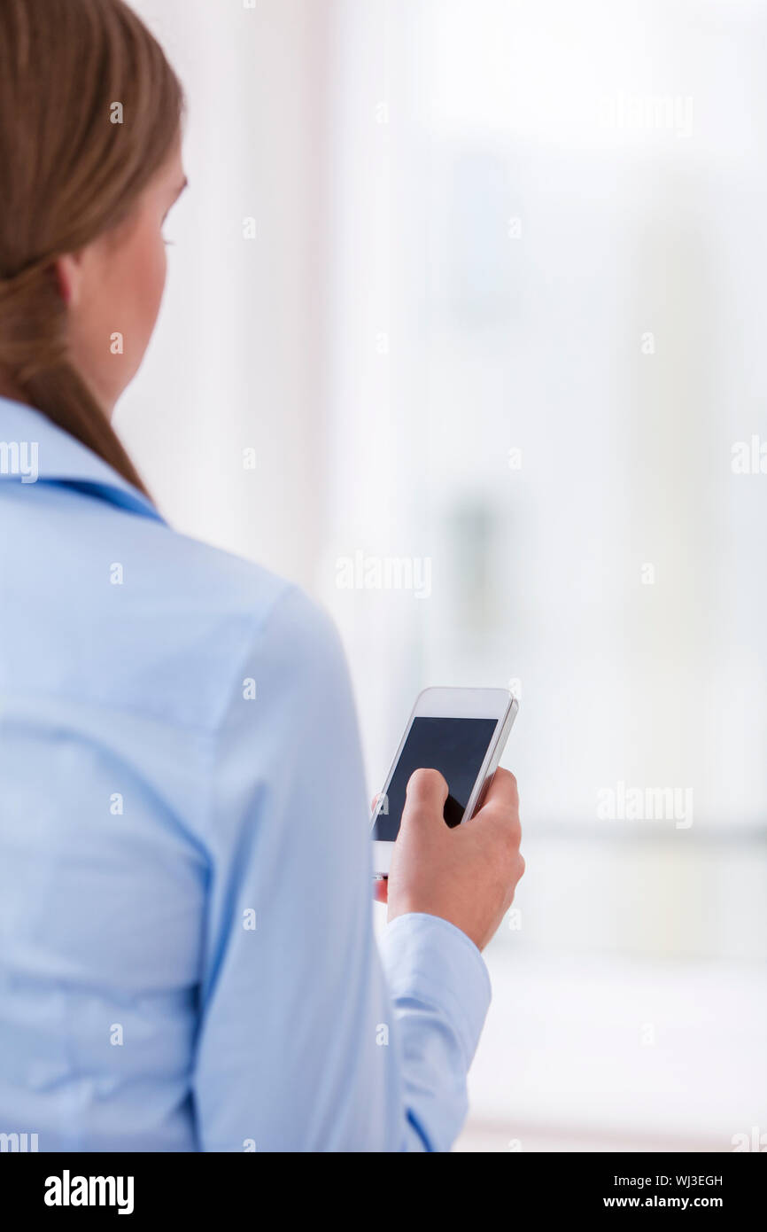 Female rear view mobile texting hi-res stock photography and images - Alamy