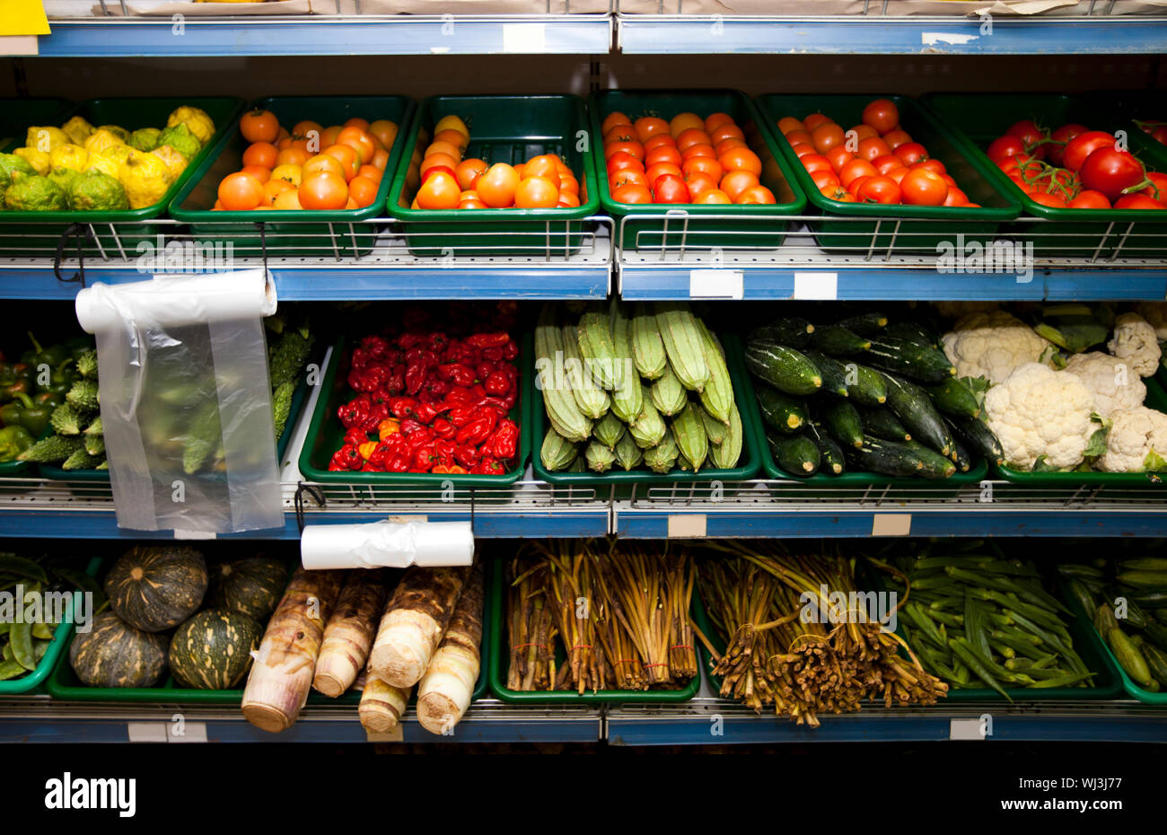 Various vegetables on shelves in grocery store Stock Photo Alamy