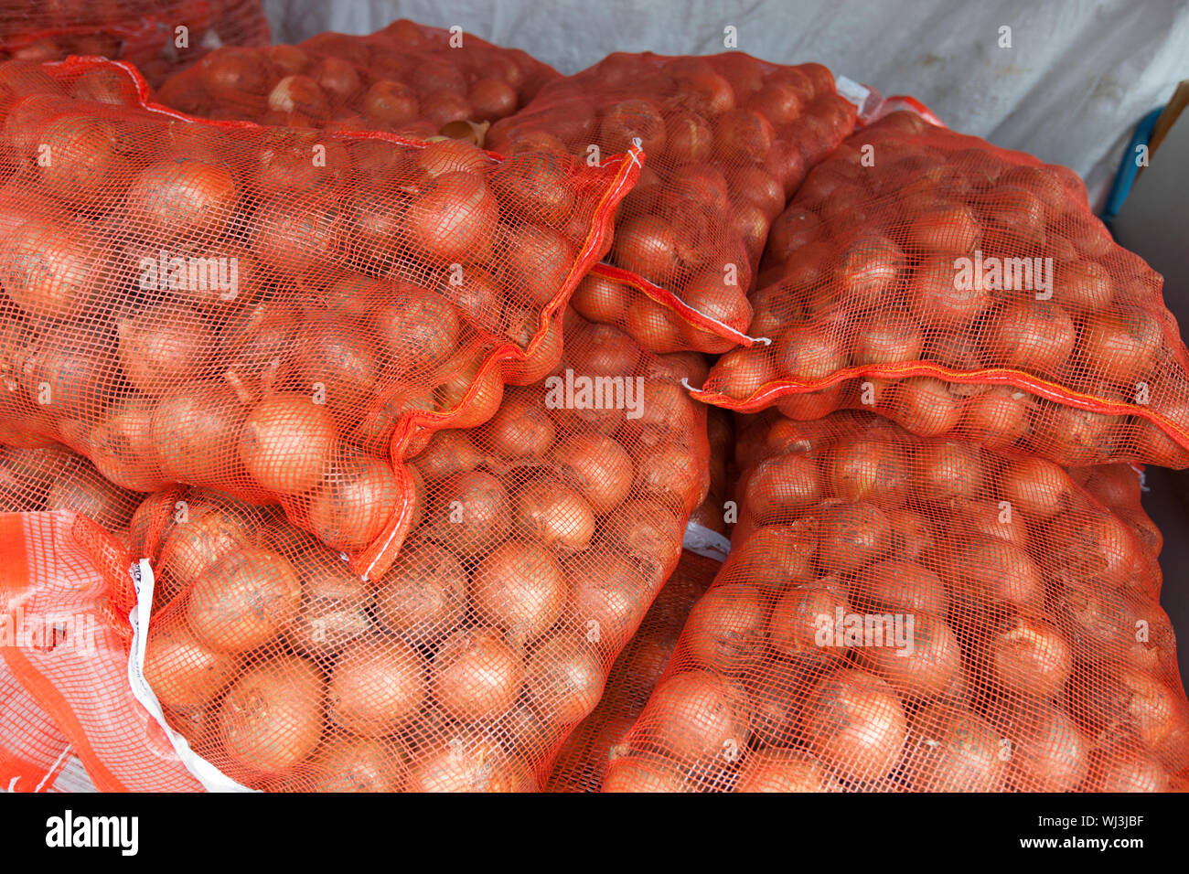 Stack of onion sacks in grocery store Stock Photo Alamy