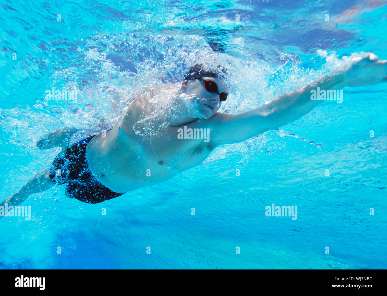 Underwater shot of professional male athlete swimming in pool