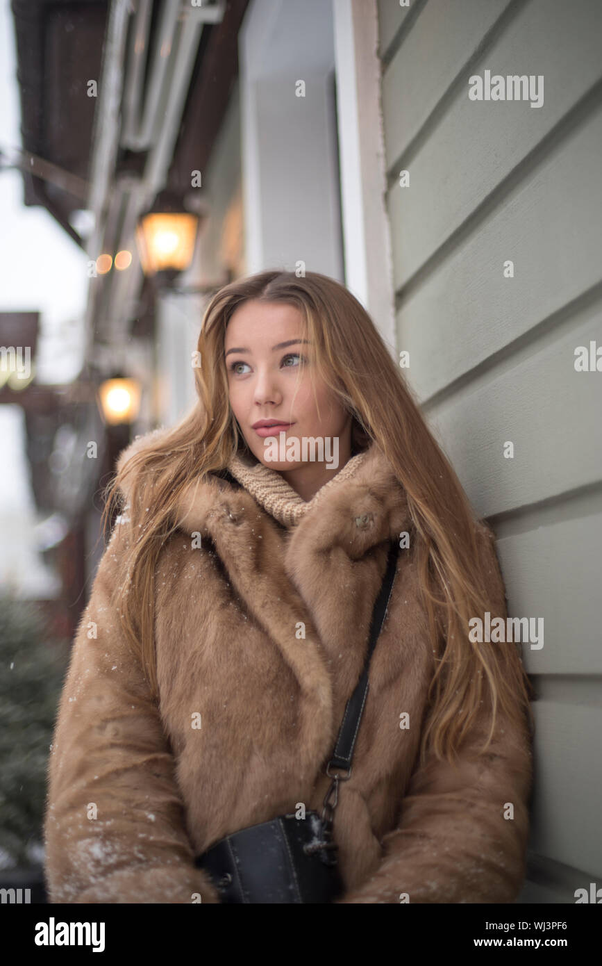 girl in a fur coat walking in the city Stock Photo - Alamy
