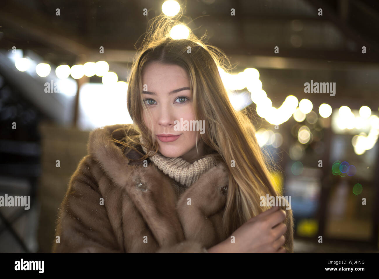 girl in a fur coat walking in the city Stock Photo - Alamy