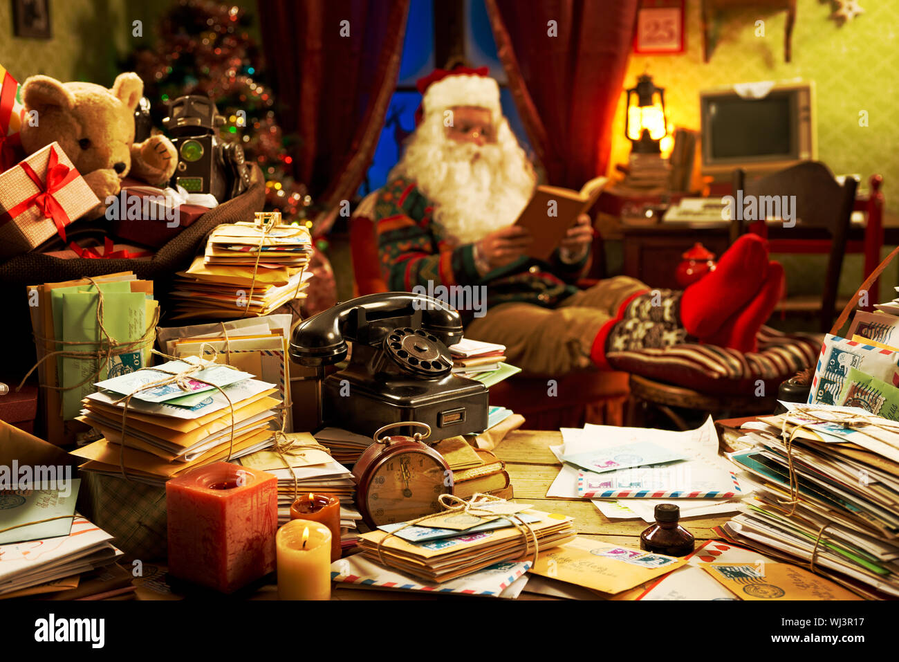 The messy desk of Santa Claus he reading a book Stock Photo Alamy