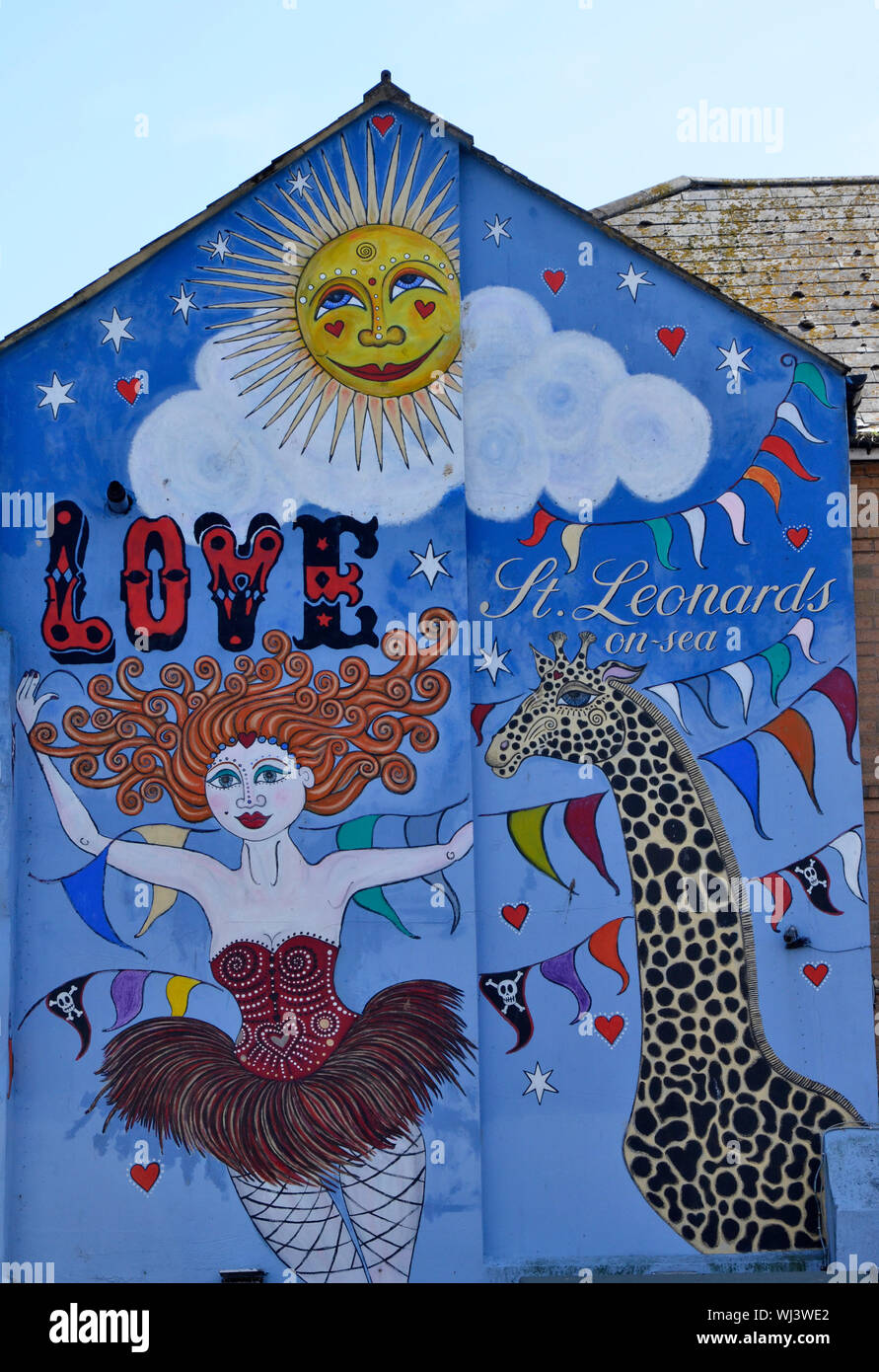 A welcoming mural on a café in St. Leonards, Hastings. Stock Photo
