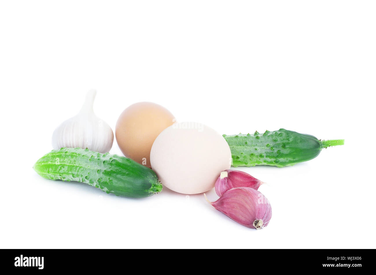 Eggs garlic and cucumbers on white isolated background, diet vegetables