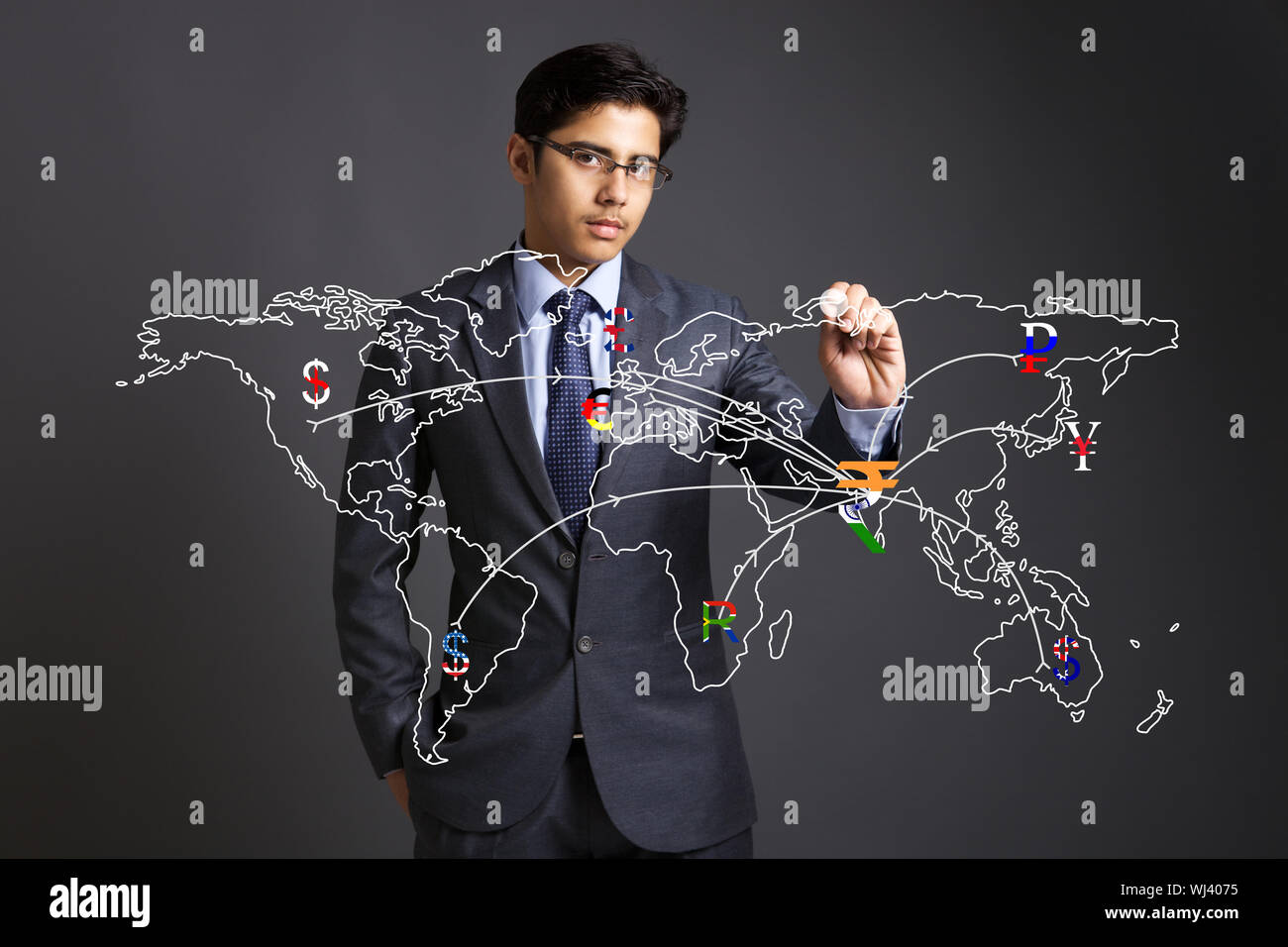 Businessman touching currency symbols on a touch screen representing countries in a world map Stock Photo