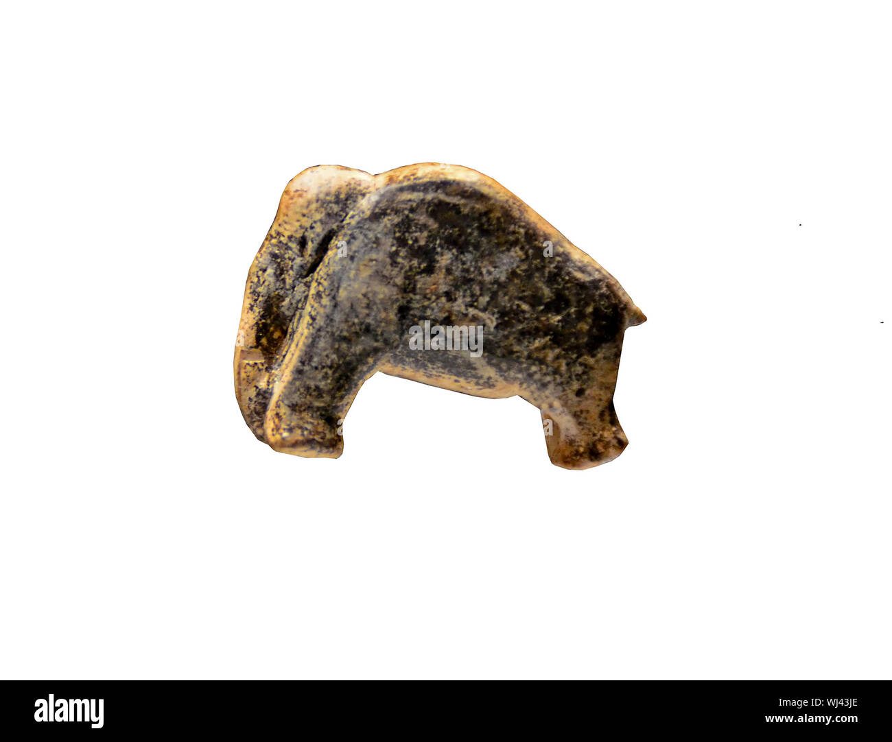 The tiny but beautiful Vogelherd Mammoth figurine, dating from around 35,000 years ago. Sculted from Mammoth Ivory. Isolated against a white backgroun Stock Photo