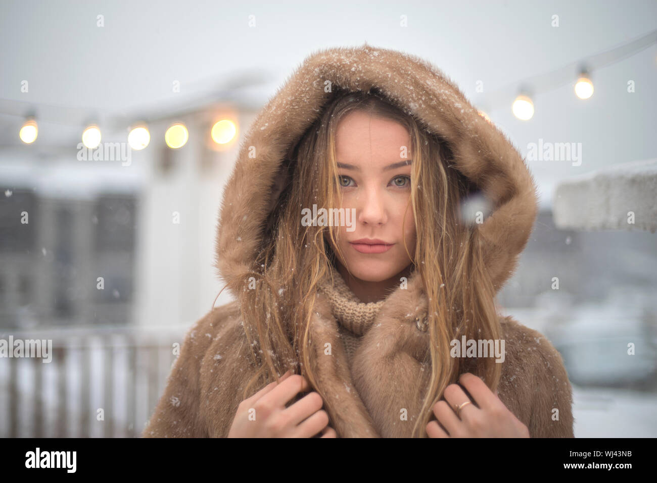 girl in a fur coat walking in the city Stock Photo - Alamy