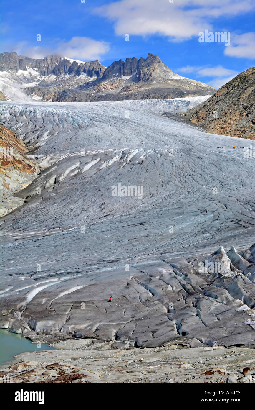 The Rhone Glacier and the glacial lake which marks the birth of the River Rhone in the Swiss Alps. With the sheet protection over the ice to reduce me Stock Photo