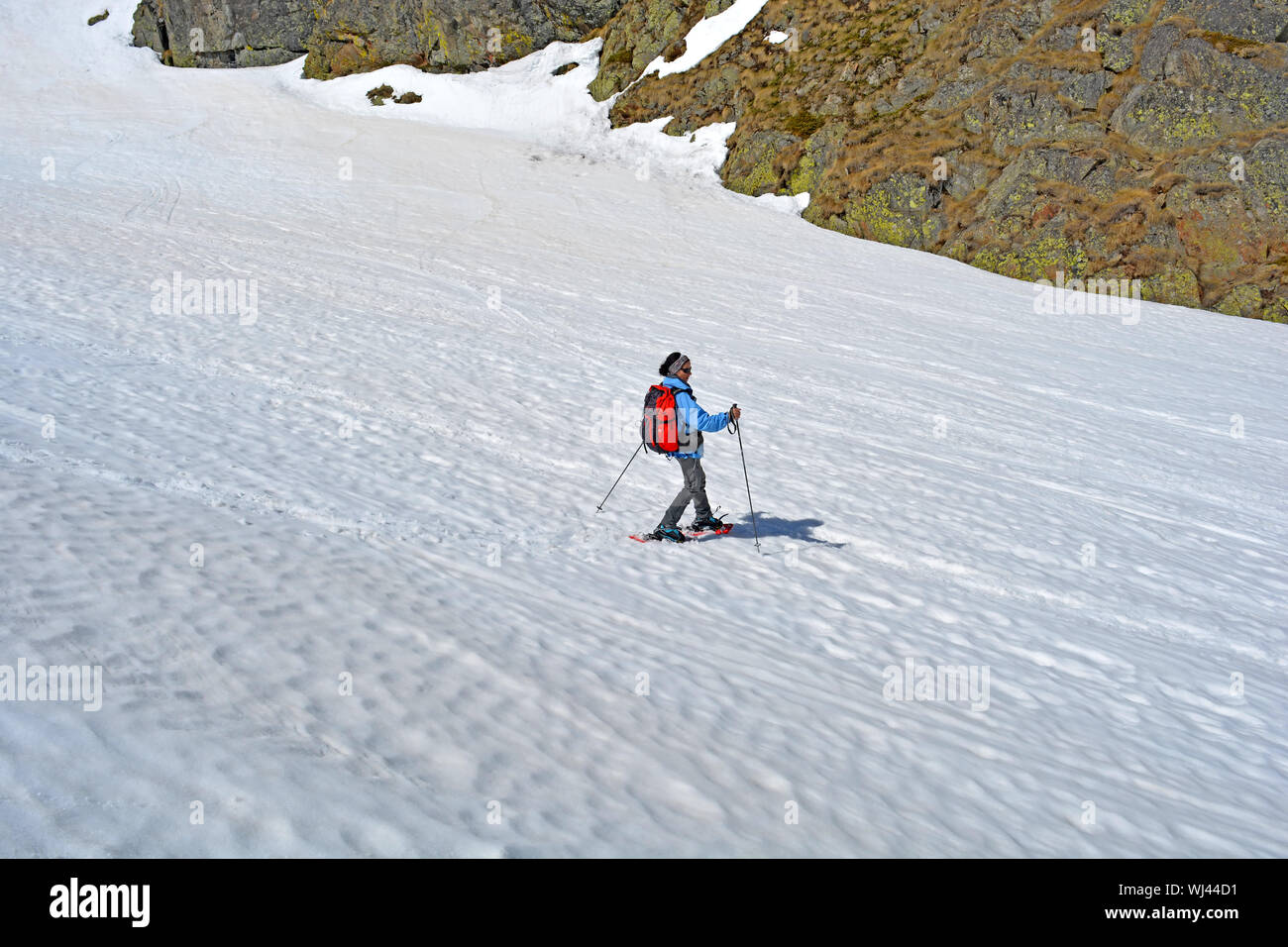 Woman hiking in the mountains with snow shoes Stock Photo