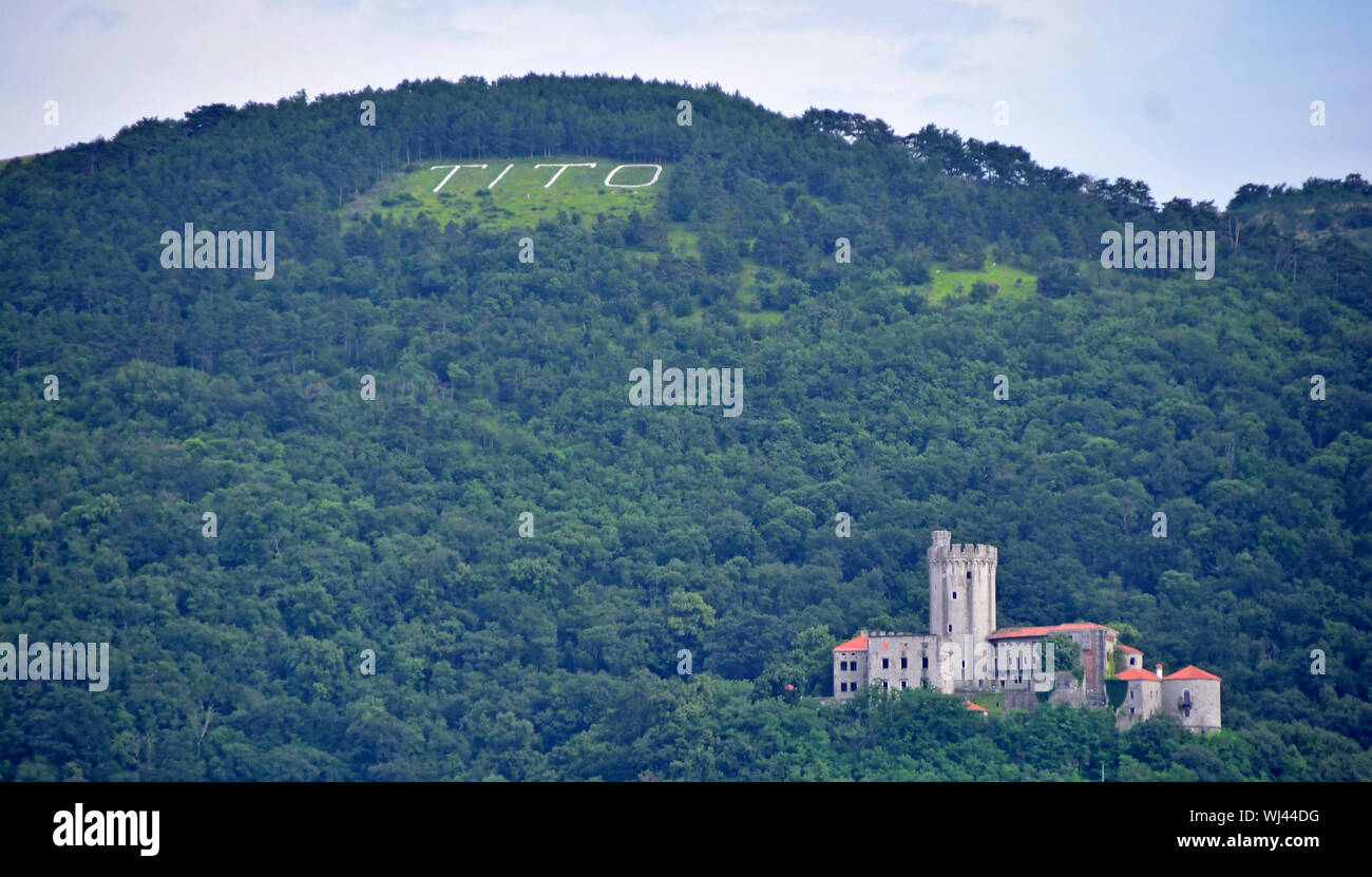 The name Tito engraved into a mountain above a castle in Slovenia. In memory of the Yugolav leader Stock Photo