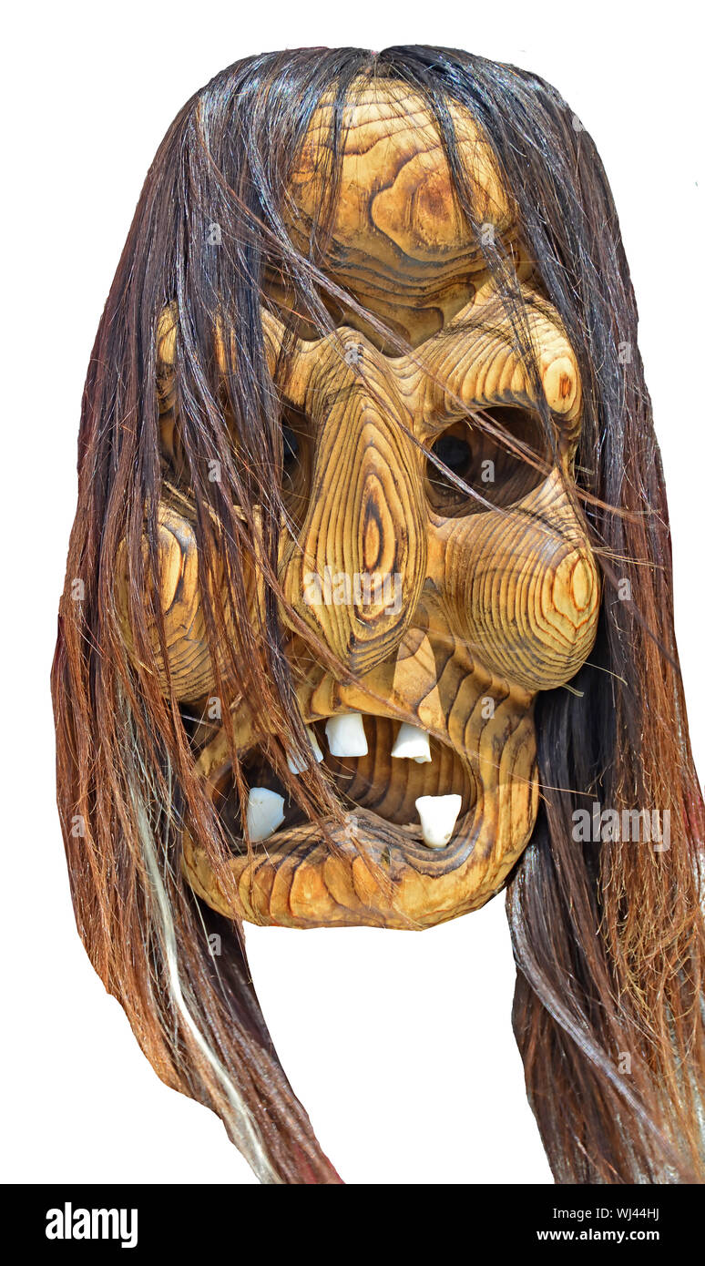 Witch mask carved from wood. Stock Photo