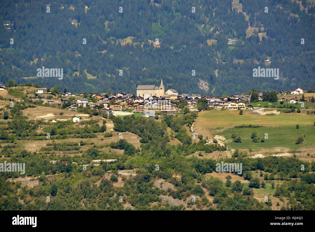 The Mountain Village of Lens in the Valais canton of Switzerland perched on a ridge Stock Photo