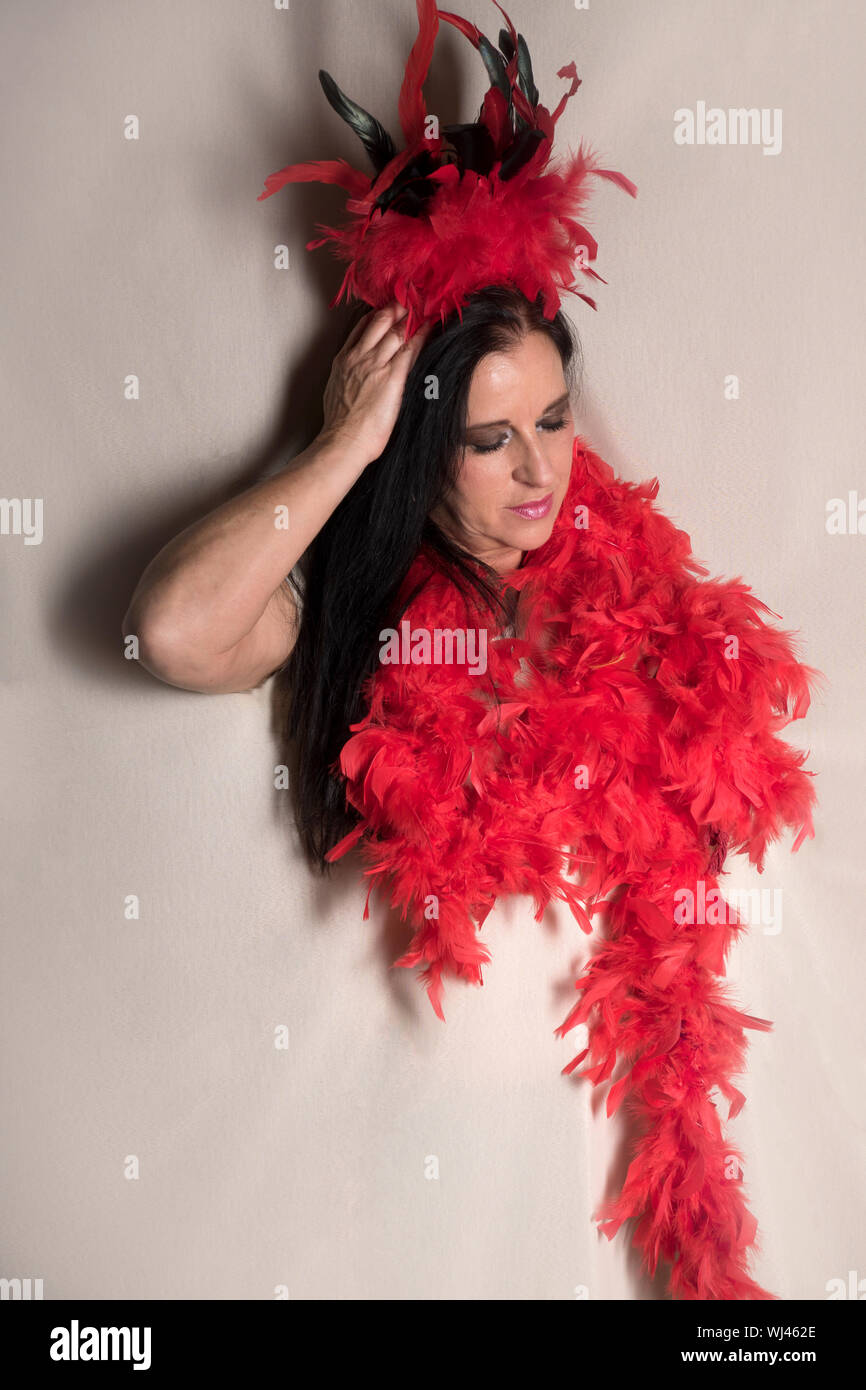 Woman Wearing Feather Boa Against White Background Stock Photo