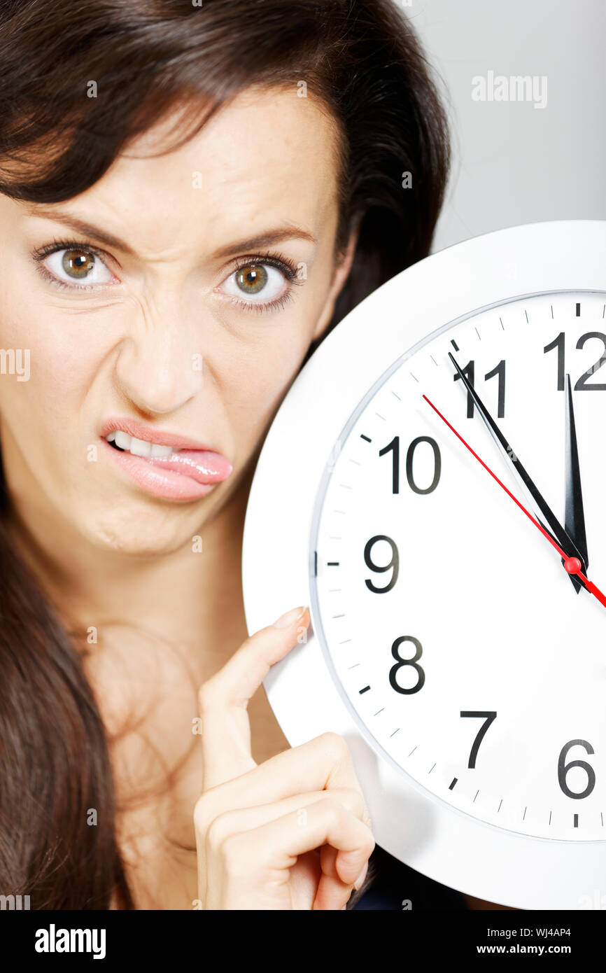 Woman with clock face looking concerned. Stock Photo