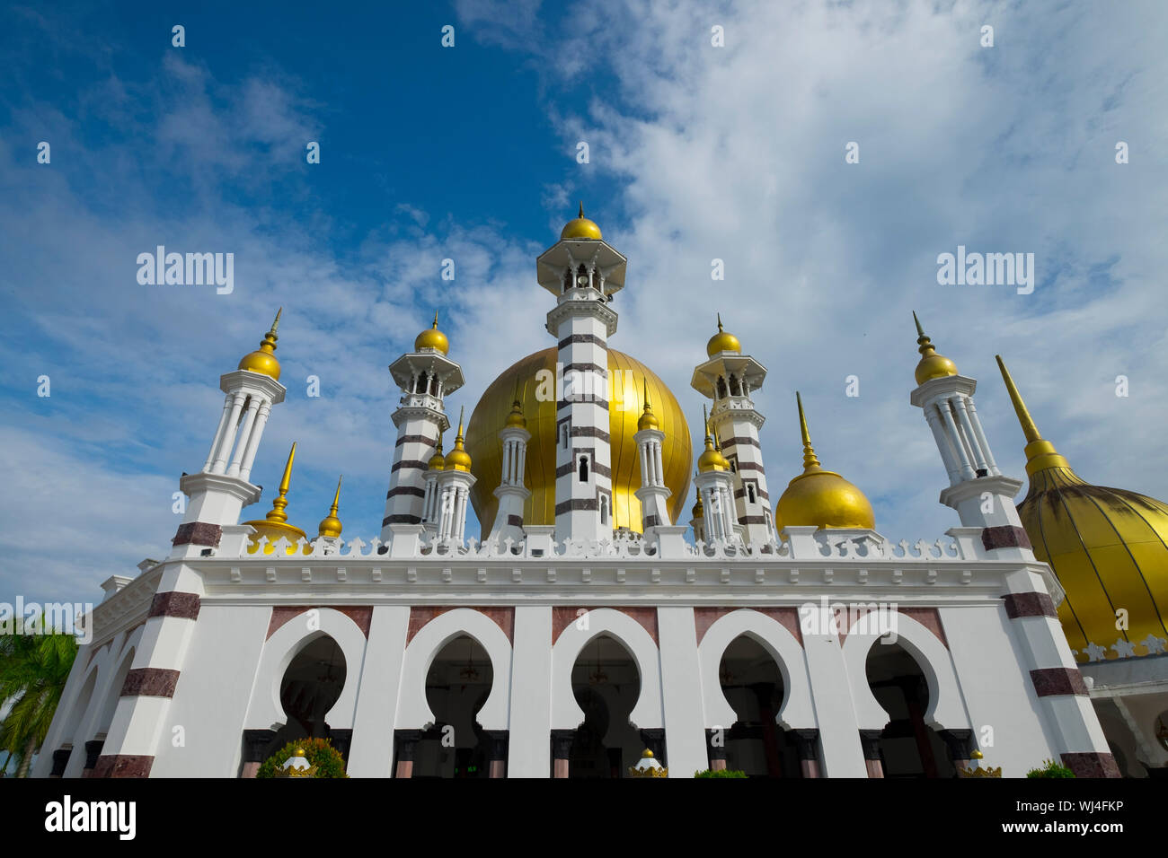 Exterior view of the striking, gold onion dome Moorish design Ubudiah Royal Mosque in Kuala