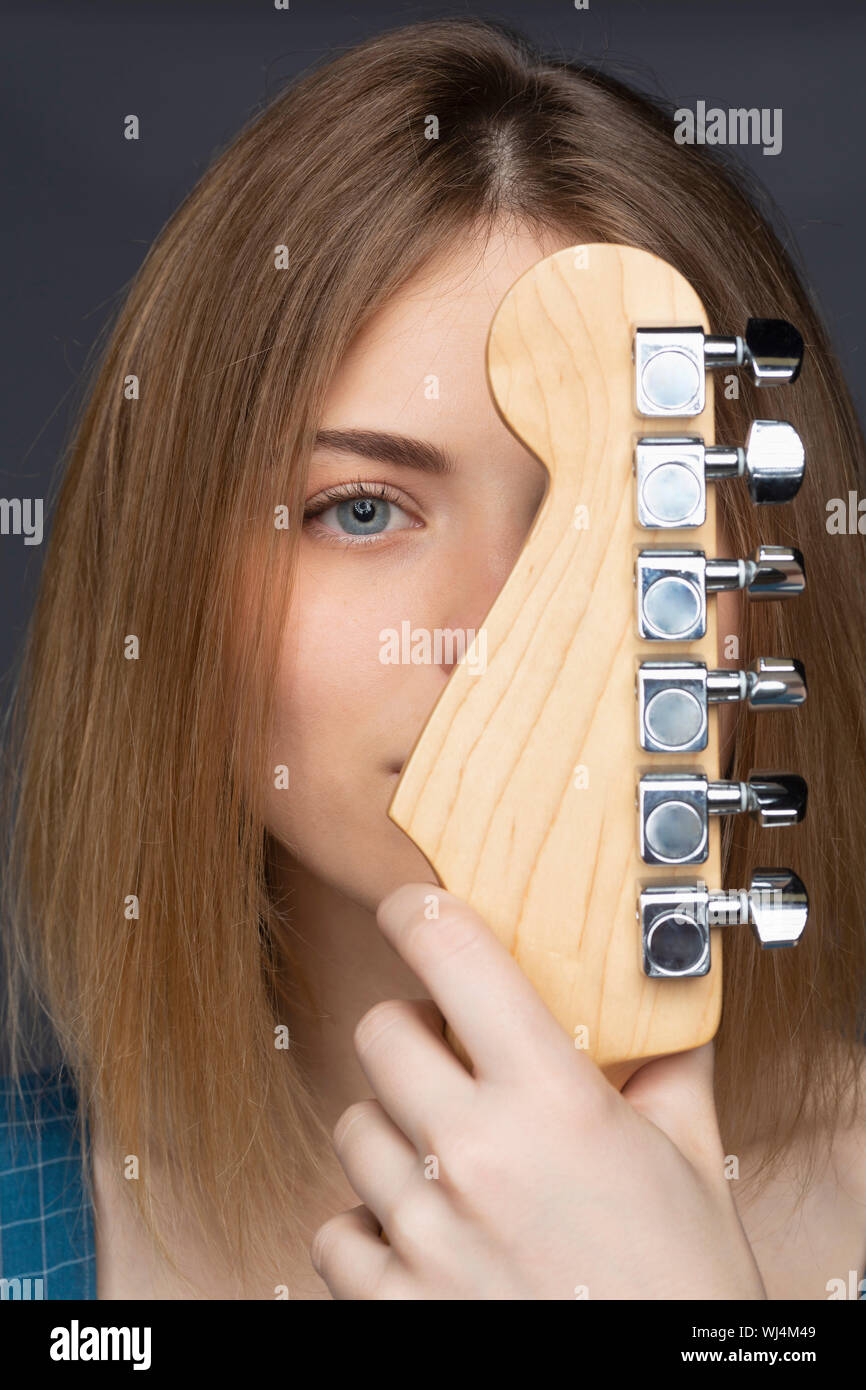 Close up portrait beautiful young woman with guitar Stock Photo