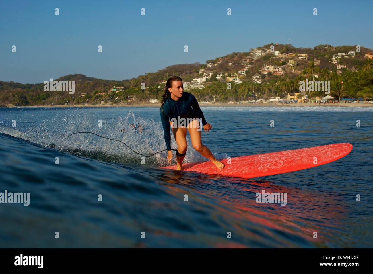 Female surfer riding ocean wave, Sayulita, Nayarit, Mexico Stock Photo