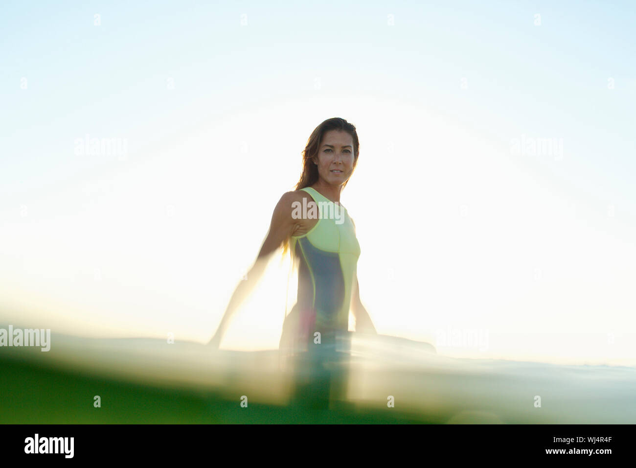 Portrait confident female surfer in ocean Stock Photo