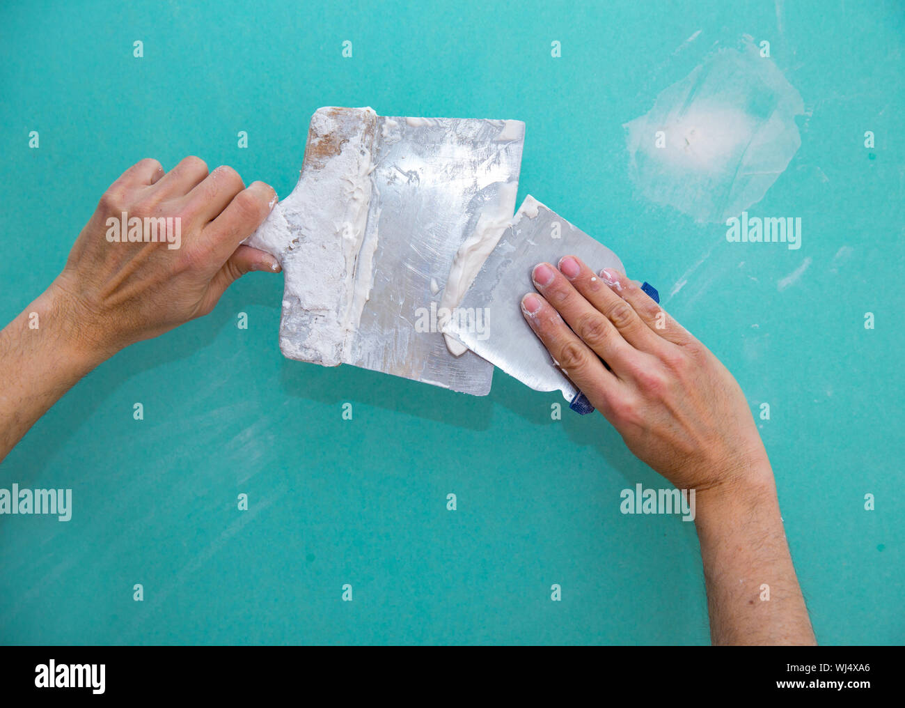 Plaster Manb Plastering man hands with plaste on drywall plasterboard hydrophobic ...