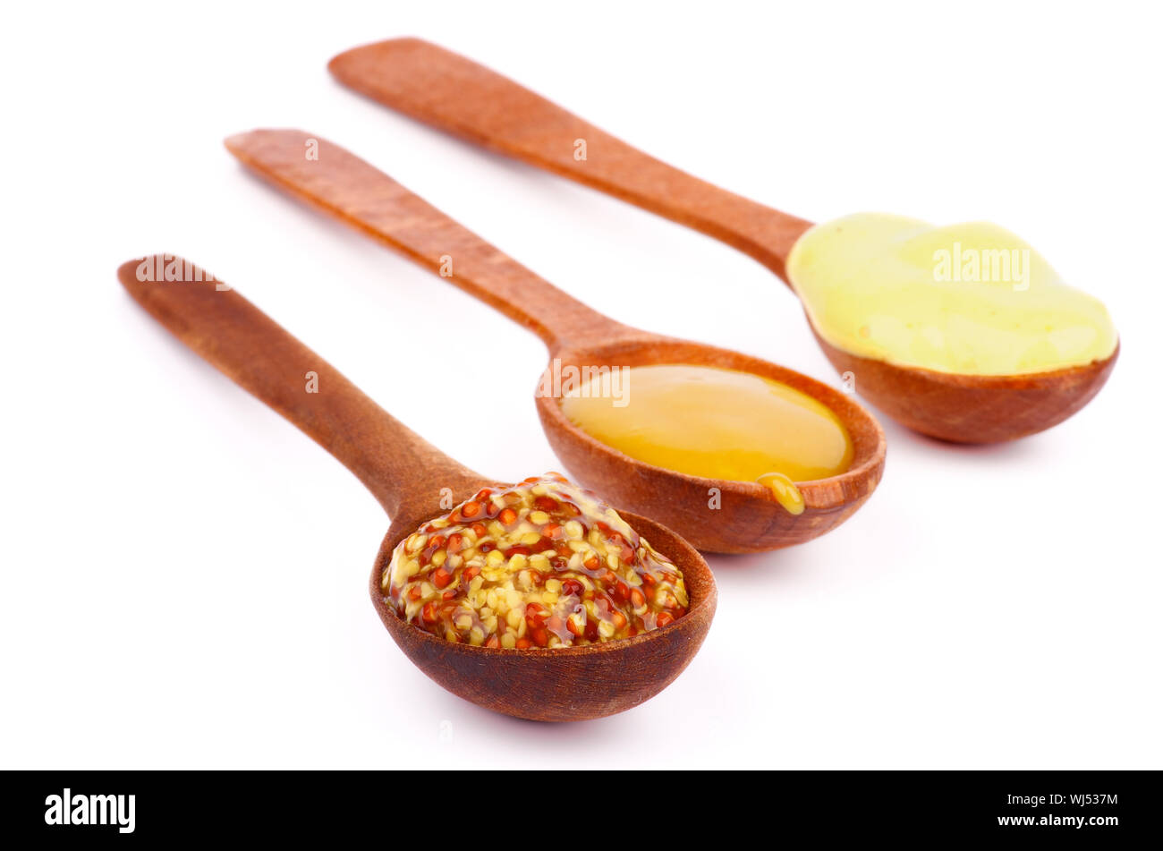 Wooden Spoons with Honey, Dijon and Whole Grain Mustards In a Row on