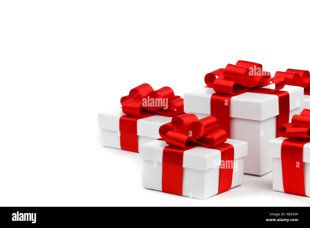 Gift boxes with red ribbon bows on white background Stock Photo - Alamy