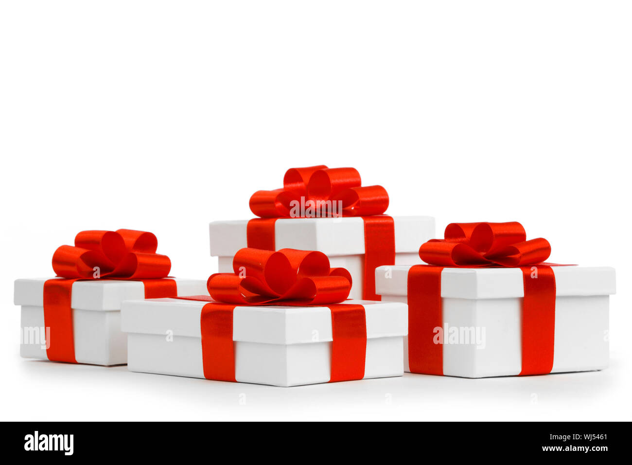 Gift boxes with red ribbon bows on white background Stock Photo - Alamy
