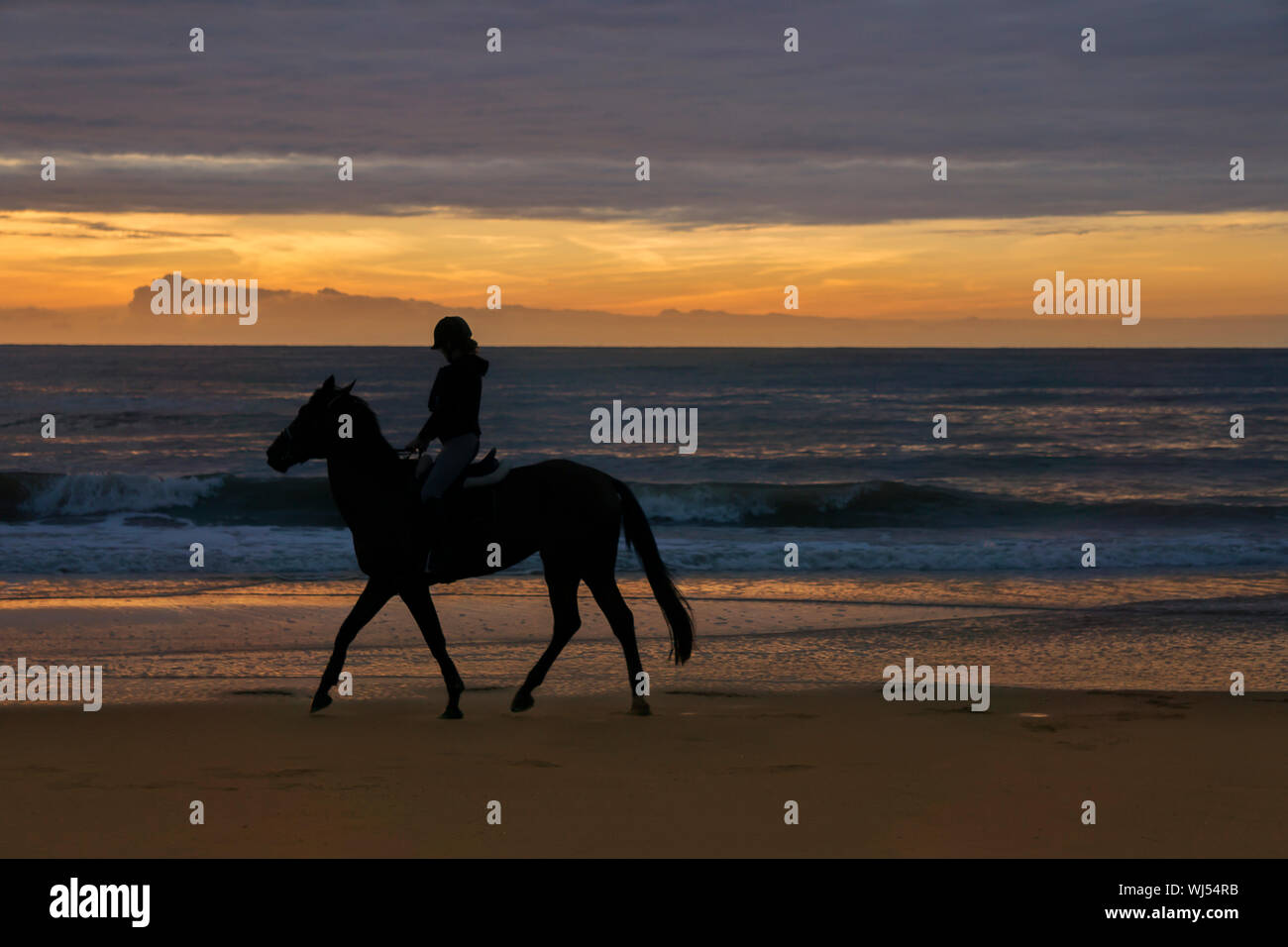 Woman riding horse beach sunset hi-res stock photography and images - Alamy