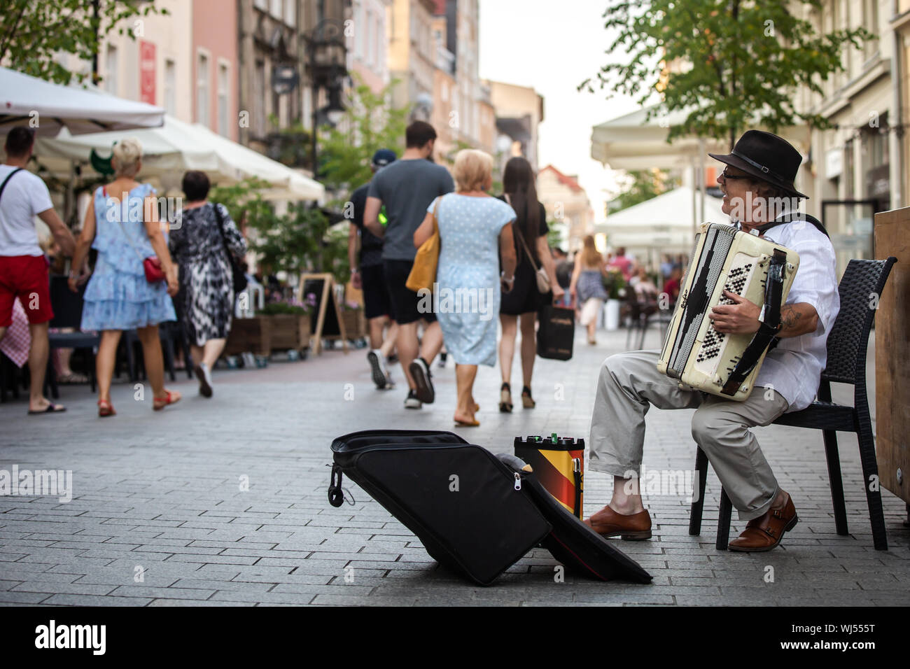 An accordion player performing on the street in the city center. Stock Photo