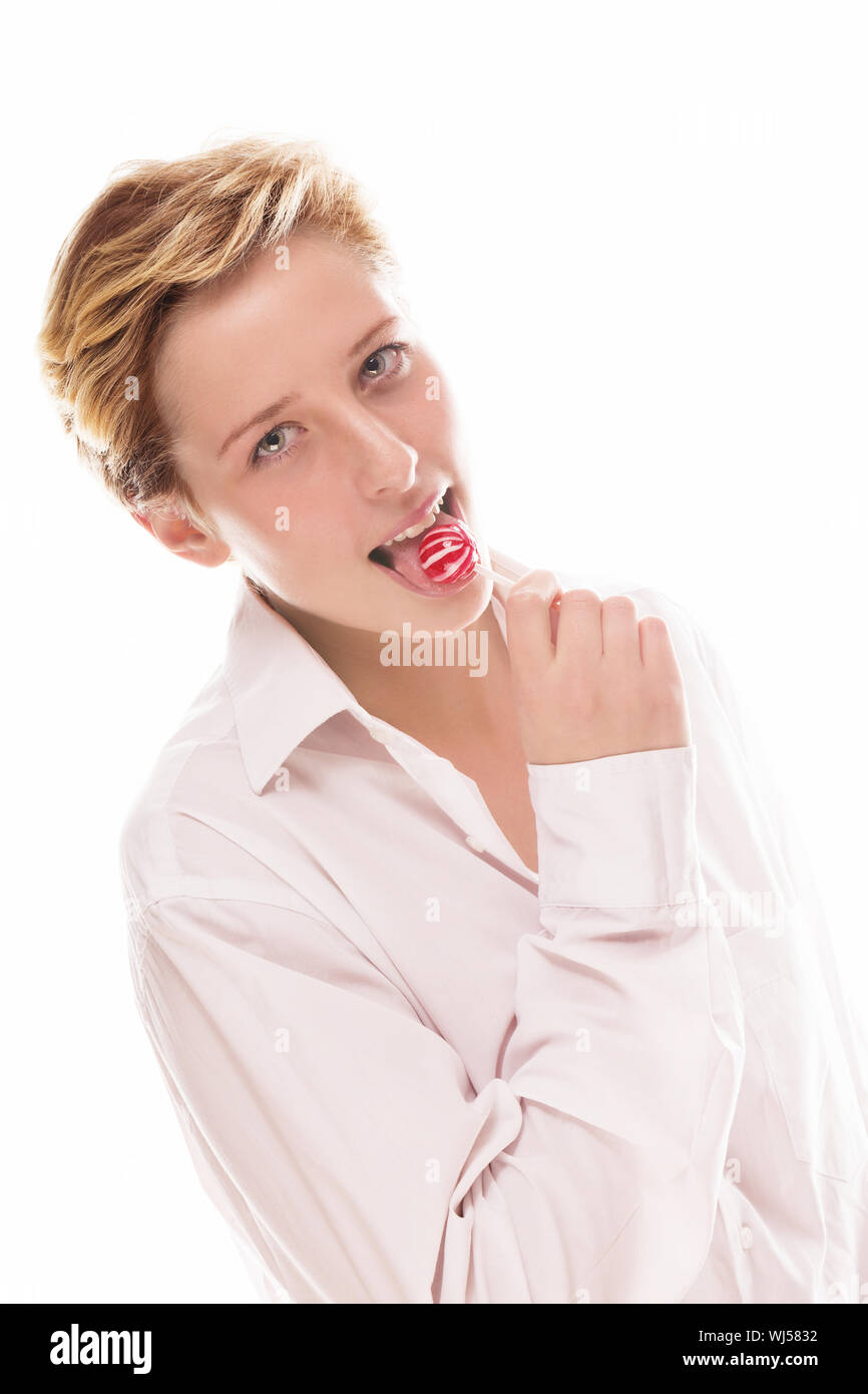 blonde woman licking a red lollipop on white background Stock Photo
